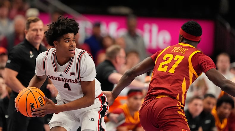 Texas Tech's Christian Anderson (4) looks to pass round Iowa State's Killyan Toure (27) during the first half of an NCAA college basketball game in the quarterfinal round of the Big 12 Conference tournament Thursday, March 12, 2026, in Kansas City, Mo. (AP Photo/Charlie Riedel)