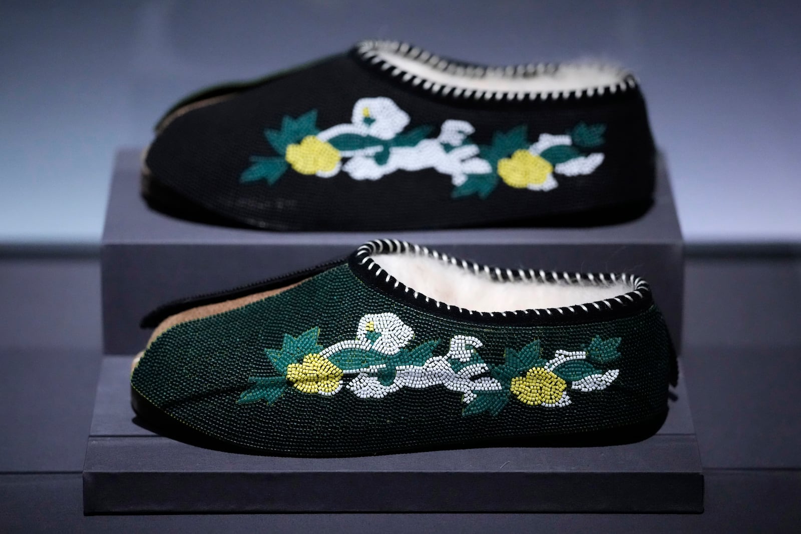 Slippers designed by Tremaine Emory for Denim Tears are displayed at the Metropolitan Museum of Art's Costume Institute exhibition, "Superfine: Tailoring Black Style," on Saturday, May 3, 2025, in New York. (Photo by Charles Sykes/Invision/AP)
