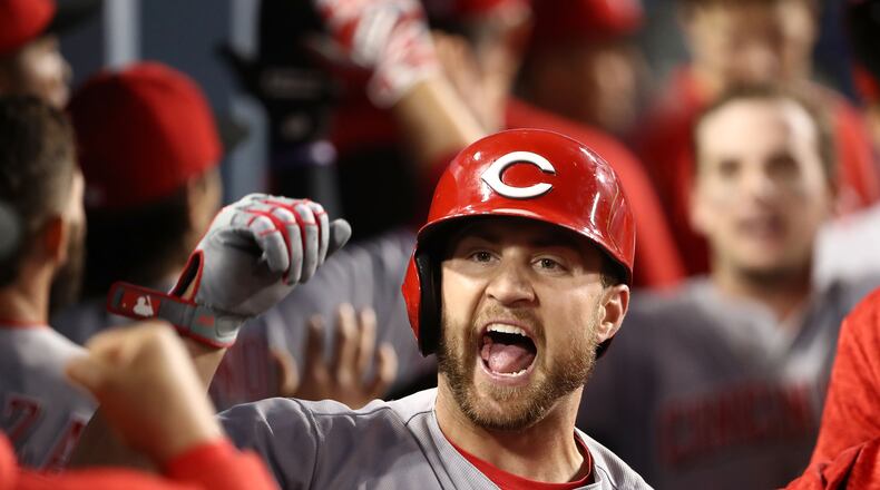 LOS ANGELES, CA - MAY 12: Scott Schebler #43 of the Cincinnati Reds celebrates with teammates in the dugout after hitting a three-run homerun to take a 4-3 lead in the sixth inning of the MLB game against the Los Angeles Dodgers at Dodger Stadium on May 12, 2018 in Los Angeles, California. The Reds defeated the Dodgers 5-3. (Photo by Victor Decolongon/Getty Images)