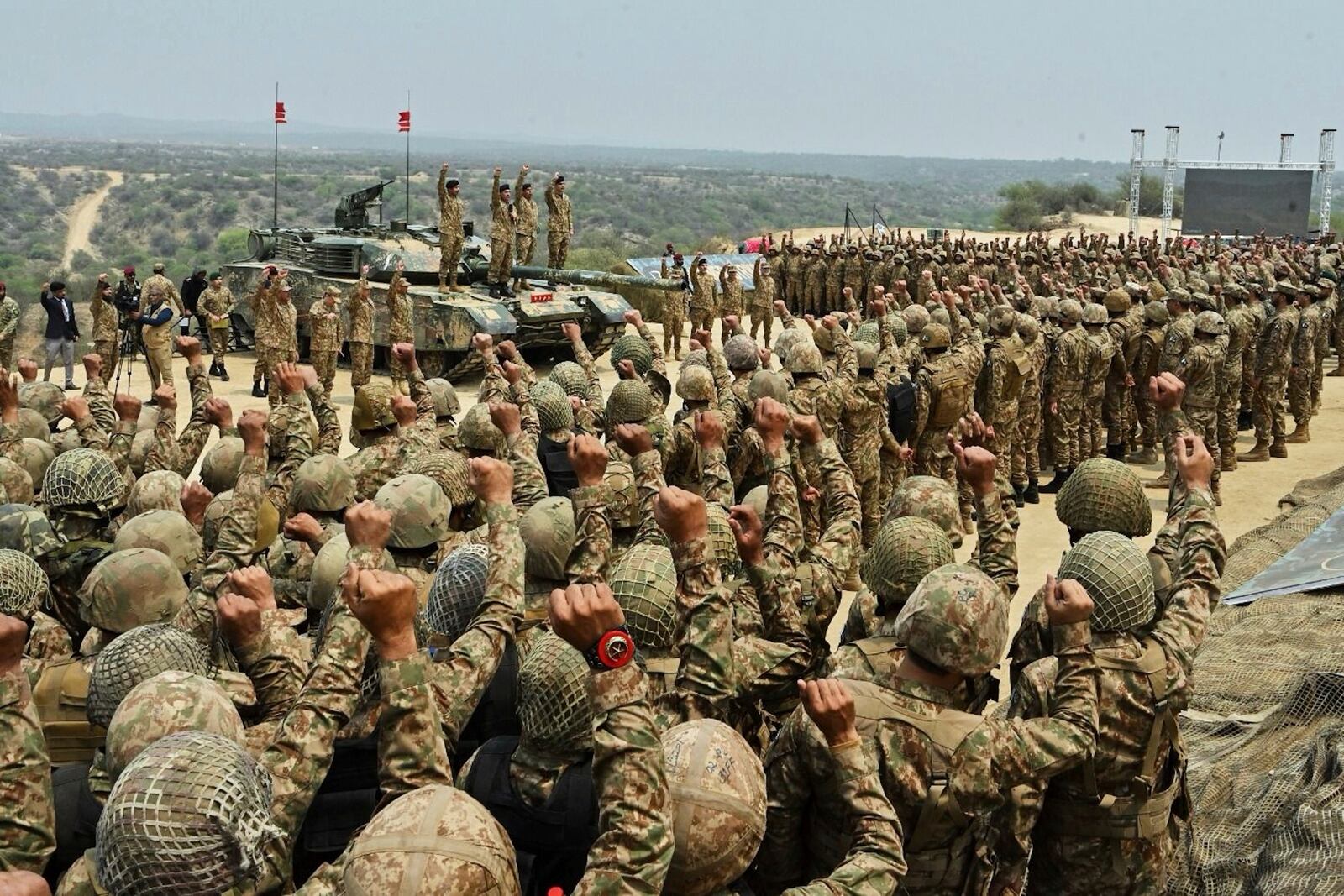 In this photo released by the Inter Services Public Relations, Pakistan's Army Chief Asim Munir, second left standing on tank, chant 'long live Pakistan' slogans with soldiers during his visit to witness military exercises, in Tilla Field Firing Range in the Jhelum district, Pakistan, Thursday, May 1, 2025. (Inter Services Public Relations via AP)