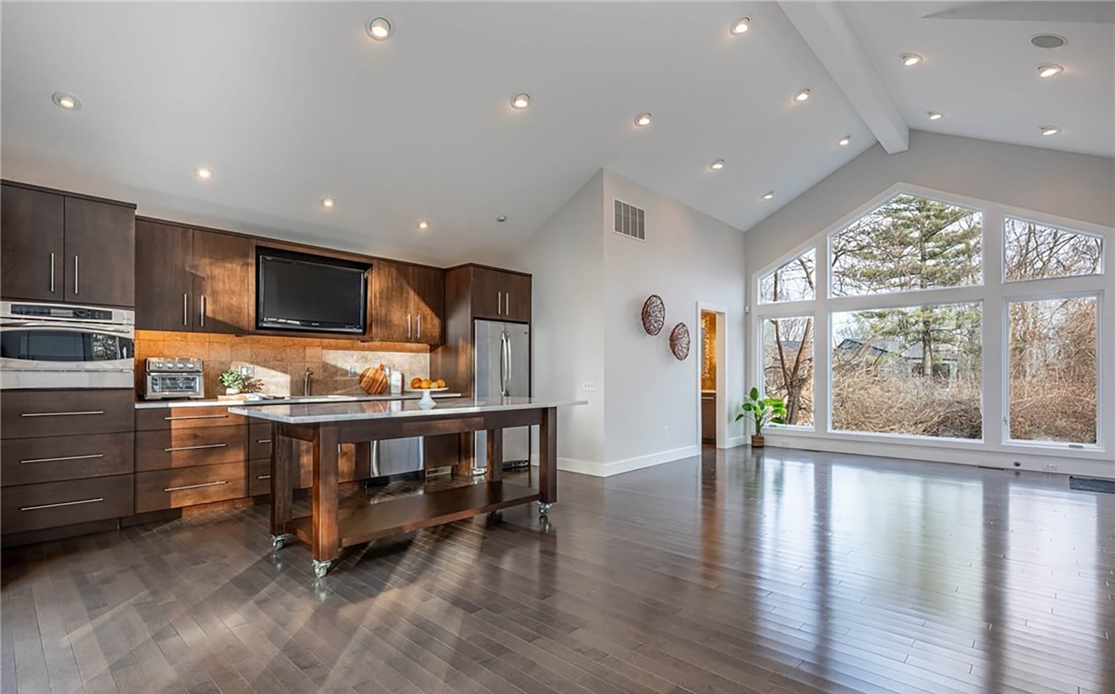 The detached garage has an upper level studio with a kitchenette. It has hardwood floors, a vaulted ceiling and wood cabinets. There is also a bathroom and a private patio. CONTRIBUTED