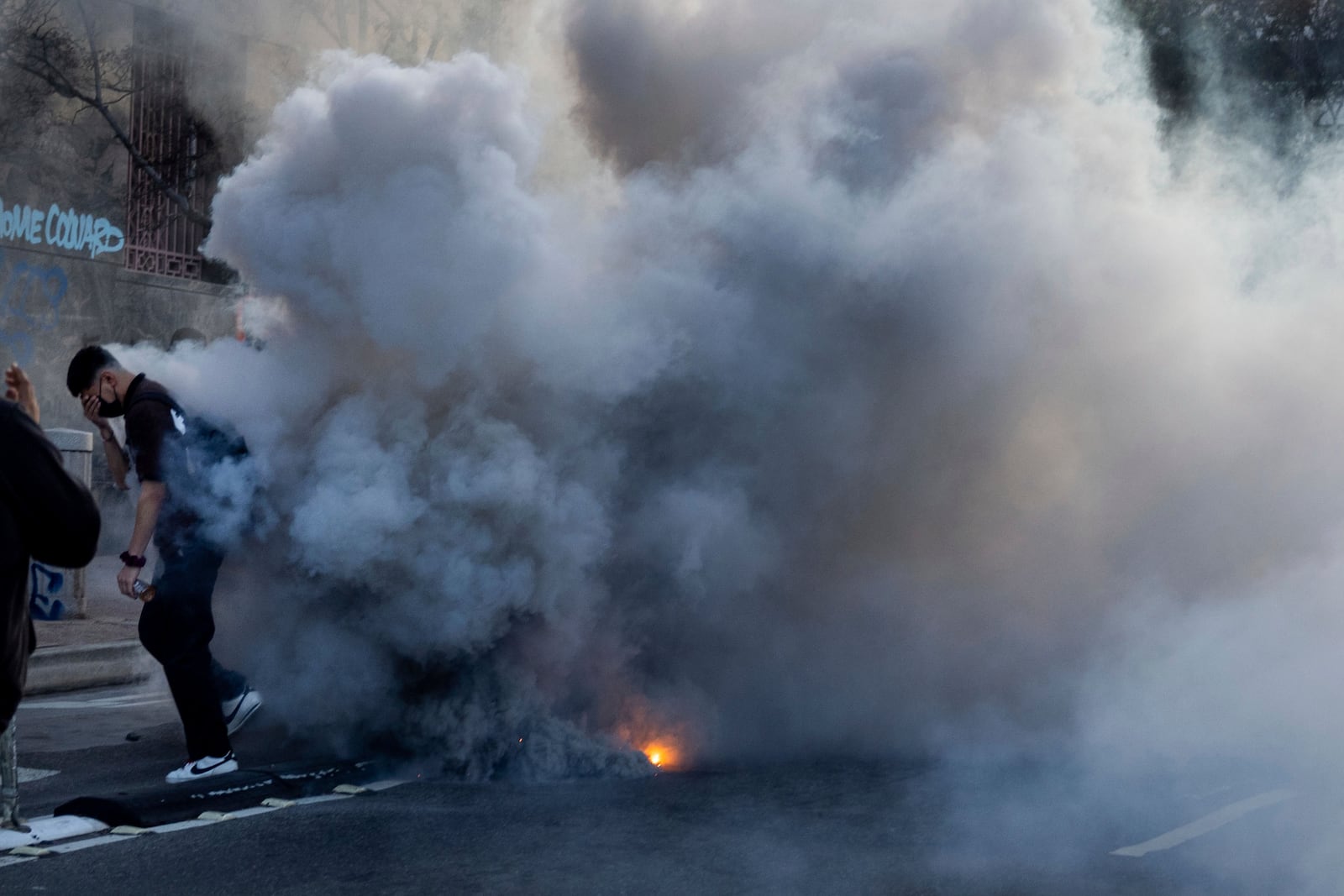 FILE - A person reacts to irritants during protests near the Metropolitan Detention Center in downtown Los Angeles, Sunday, June 8, 2025. (AP Photo/Ethan Swope, File)