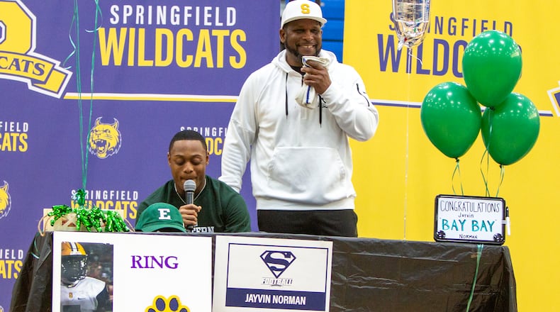 Springfield running back Jayvin "Bay Bay" Norman thanks those who helped him and announces his decision to attend Eastern Michigan while head coach Maurice Douglass laughs at Norman's remarks on Wednesday in the school gym. Jeff Gilbert/CONTRIBUTED