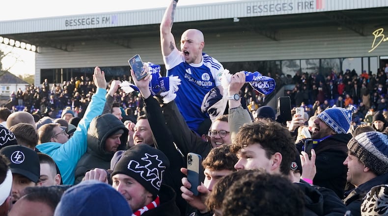 Macclesfield Town's Josh Kay celebrates with fans following the FA Cup third round soccer match between Macclesfield Town and Crystal Palace, at the Leasing.com Stadium, Macclesfield, England, Saturday, Jan. 10, 2026. (Martin Rickett/PA via AP)