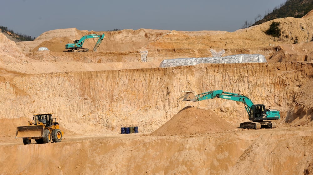 FILE - Workers use machinery to dig at a rare earth mine in Ganxian county in central China's Jiangxi province on Dec. 30, 2010. (Chinatopix via AP, File)