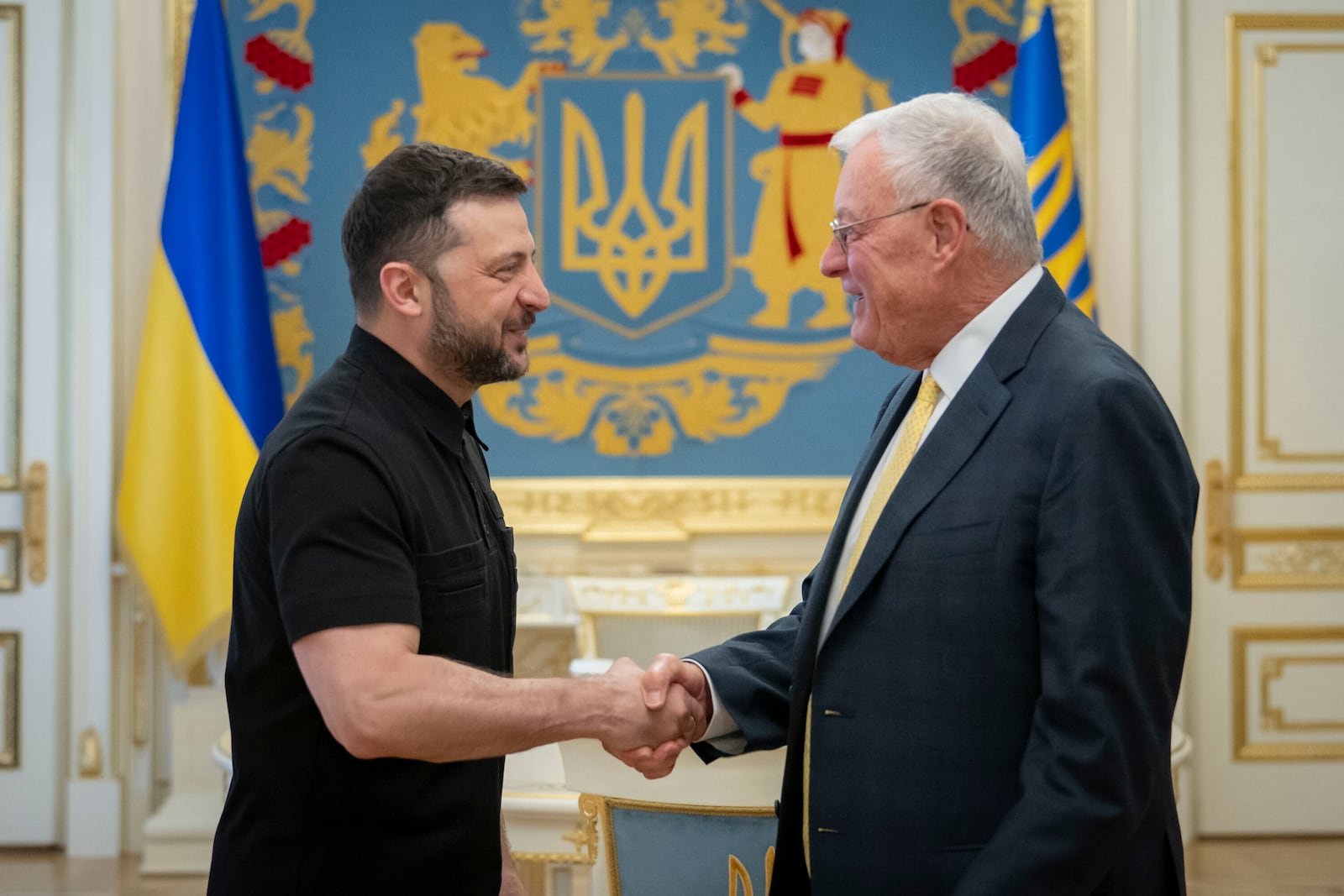 Ukrainian President Volodymyr Zelenskyy, left, shakes hands with United States Special Envoy for Ukraine and Russia, Joseph Keith Kellogg in Kyiv, Ukraine, Monday, July 14, 2025. (Ukrainian Presidential Press Office via AP)