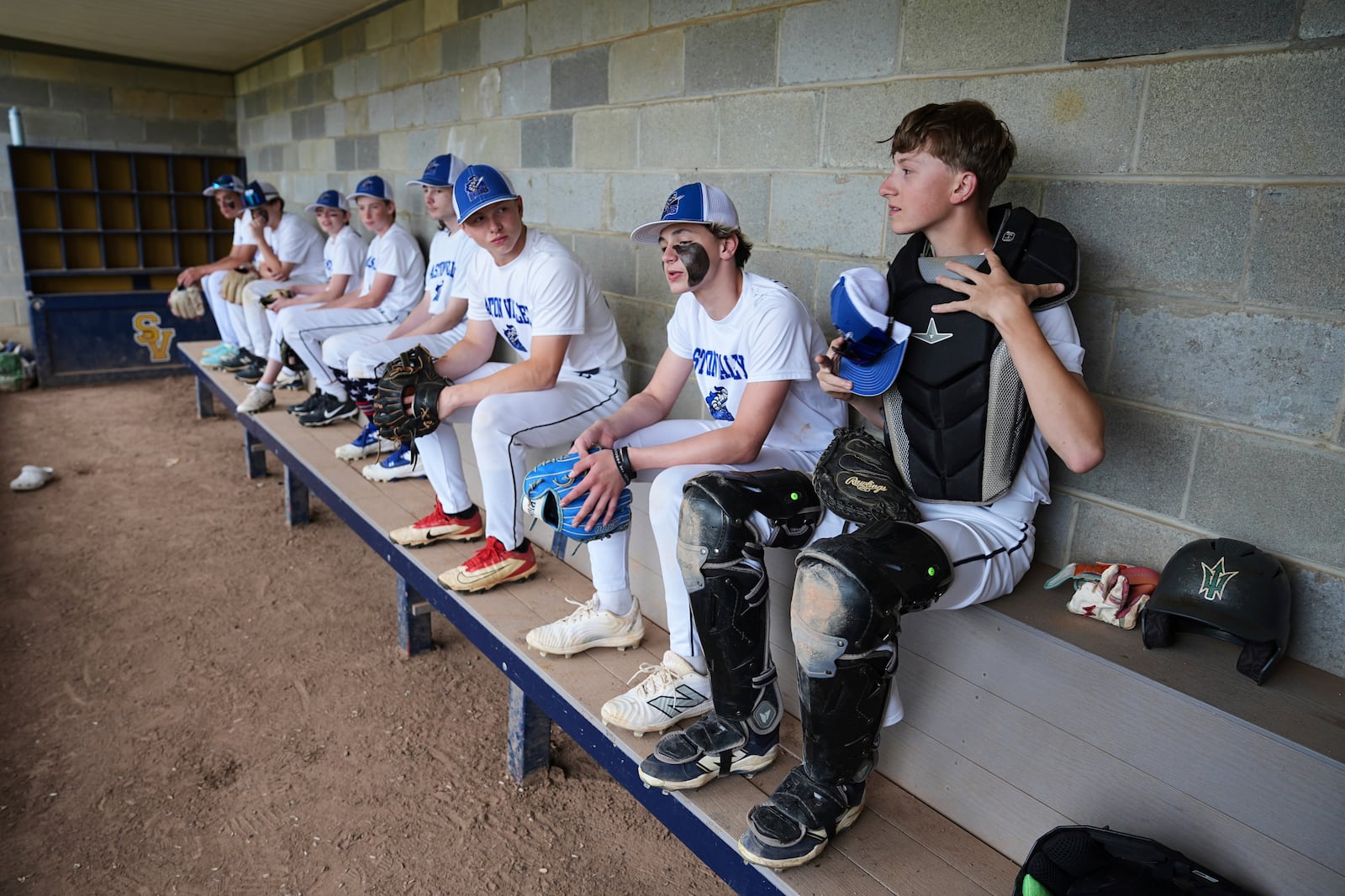 Jax Casamento, right, 15, waits prepares for the start of his youth baseball game in Aston, Pa., Tuesday, May 27, 2025. (AP Photo/Matt Rourke)