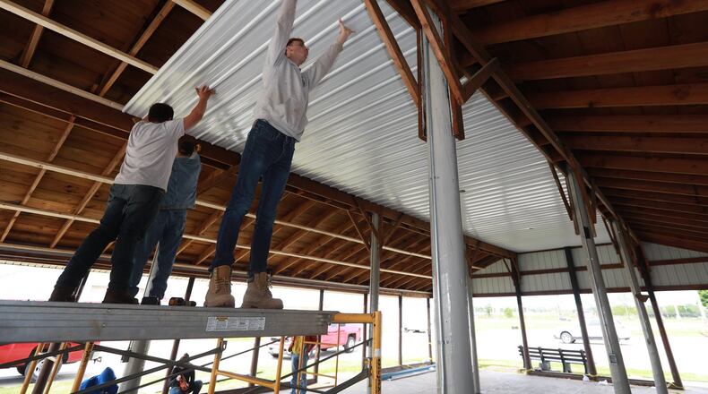 Springfield/Clark Career Technology Center students work on the new CTC Shelter House at the Clark County Fairgrounds Tuesday. BILL LACKEY/STAFF