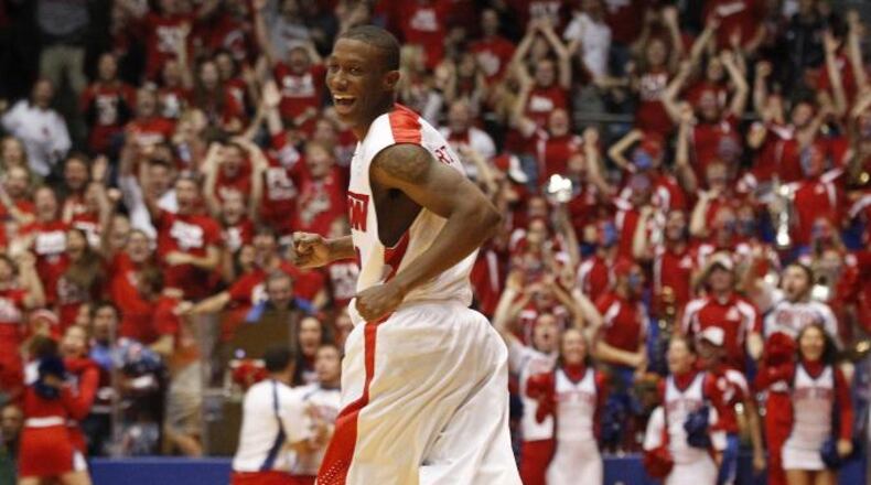 Jordan Sibert smiles as he runs back up court after a game-winning 3-pointer with 1 second left against IPFW on Saturday, Nov. 9, 2013, at UD Arena. David Jablonski/Staff