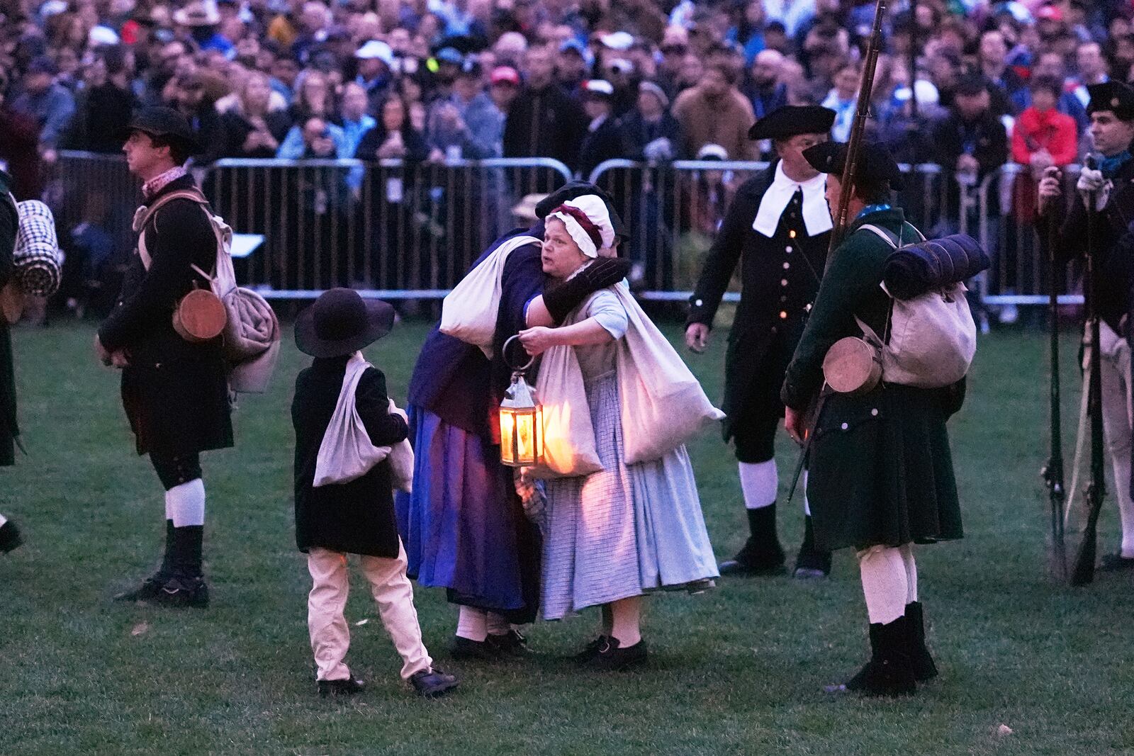 Colonials embrace while gathering prior to facing the British Regulars during a reenactment celebration of the 250th anniversary of the Battle of Lexington and start of the American Revolution, Saturday, April 19, 2025, in Lexington, Mass. (AP Photo/Charles Krupa)