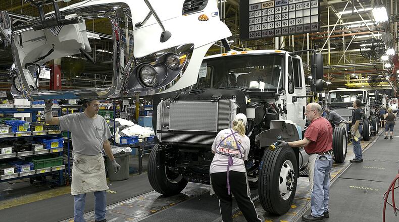 Navistar employees work on the truck assembly line in the Springfield plant Thursday. Bill Lackey/Staff