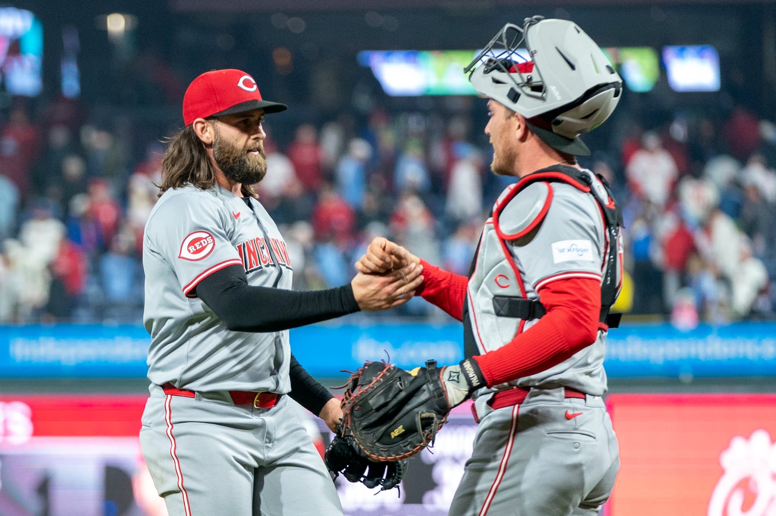 Cincinnati Reds relief pitcher Tejay Antone, left, celebrates the win with catcher Luke Maile, right, following a baseball game against the Philadelphia Phillies, Monday, April 1, 2024, in Philadelphia. (AP Photo/Chris Szagola)