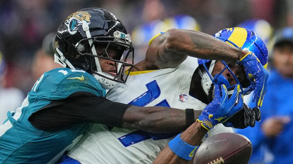 Los Angeles Rams wide receiver Davante Adams (17) is challenged by Jacksonville Jaguars wide receiver Travis Hunter (12) during the second half of an NFL football game between the Los Angeles Rams and the Jacksonville Jaguars in London, Sunday, Oct. 19, 2025. (AP Photo/Kin Cheung)