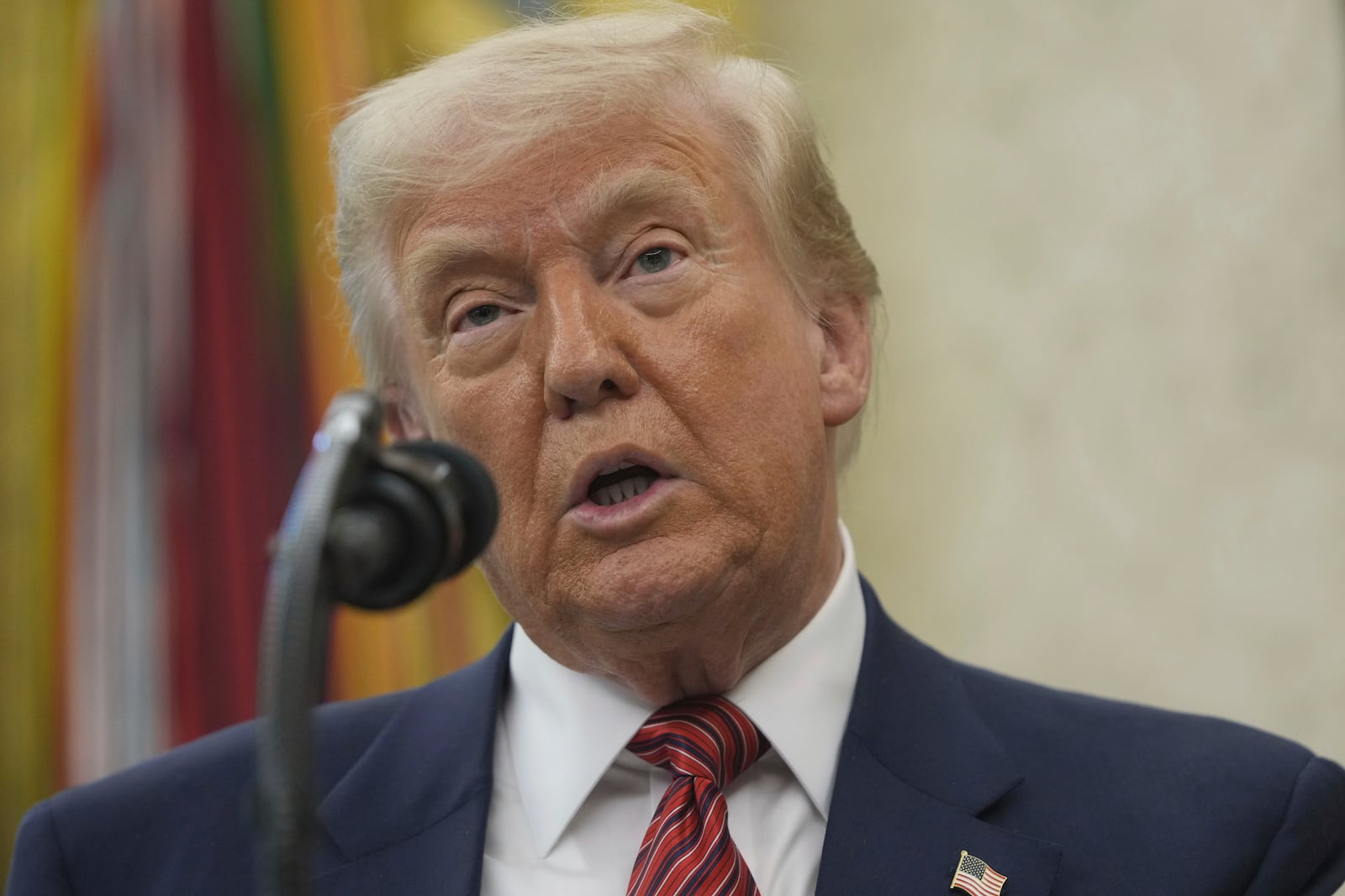 President Donald Trump speaks before David Perdue is sworn in as U.S. Ambassador to China during a ceremony in the Oval Office of the White House, Wednesday, May 7, 2025, in Washington. (AP Photo/Mark Schiefelbein)