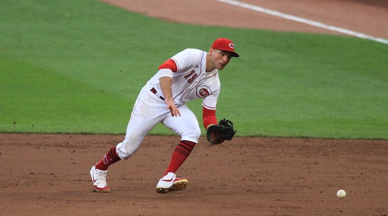 Reds first baseman Joey Votto fields a ball against the Cardinals on Monday, Aug. 31, 2020, at Great American Ball Park in Cincinnati. David Jablonski/Staff