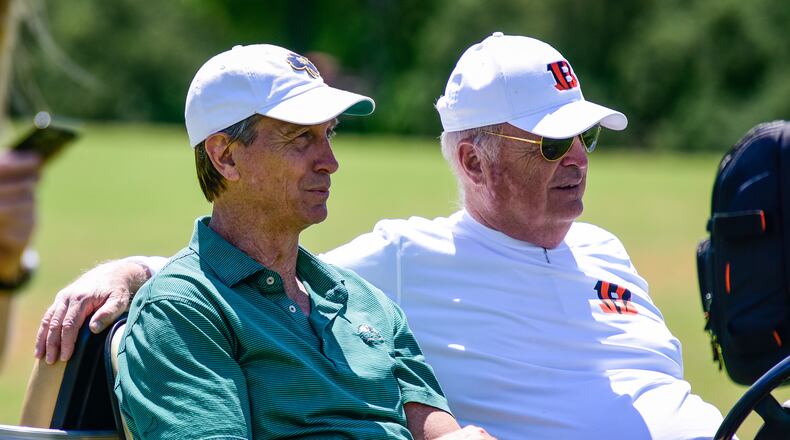 Cincinnati Bengals owner Mike Brown, right, and Cris Collinsworth watch practice Tuesday, June 6 on the practice fields next to Paul Brown Stadium in Cincinnati. NICK GRAHAM/STAFF