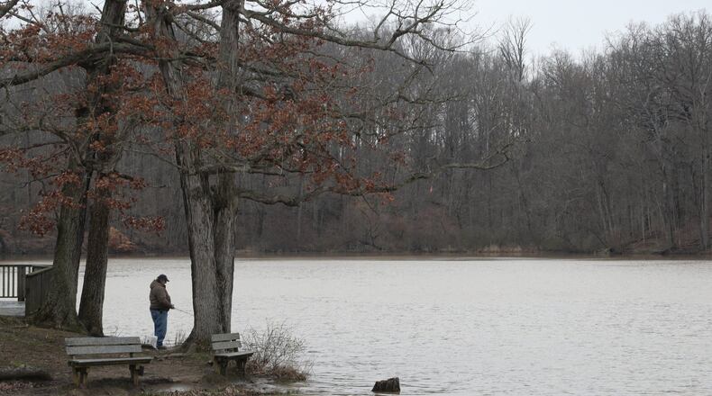 A fisherman tries his luck in Hosterman Lake at George Rogers Clark Park Friday. BILL LACKEY/STAFF