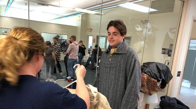 Peter Bailey, who will play lead role Jean Valjean, looks at costume options prior to rehearsal for the upcoming Youth Arts Ambassadors and Springfield Youth Symphony production of "Les Misérables" on Nov. 5-6 at the John Legend Theater. Photo by Brett Turner