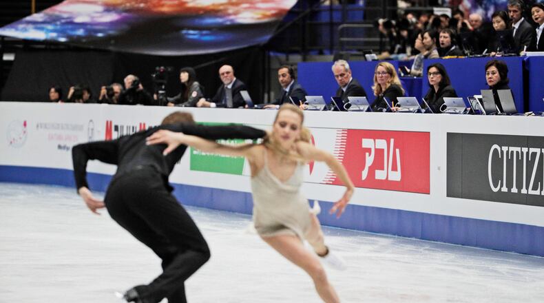 FILE - Judges watch Russia's Victoria Sinitsina and Nikita Katsalapov perform their ice dance free dance during the ISU World Figure Skating Championships at Saitama Super Arena in Saitama, north of Tokyo, March 23, 2019. (AP Photo/Andy Wong, File)