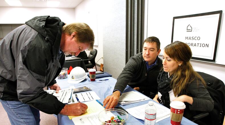 Keith Phillips (center) and Nuri Missaghian, of Masco Contractor Services in Hamilton, talk with Richard Chrisman during a recent manufacturing job fair.