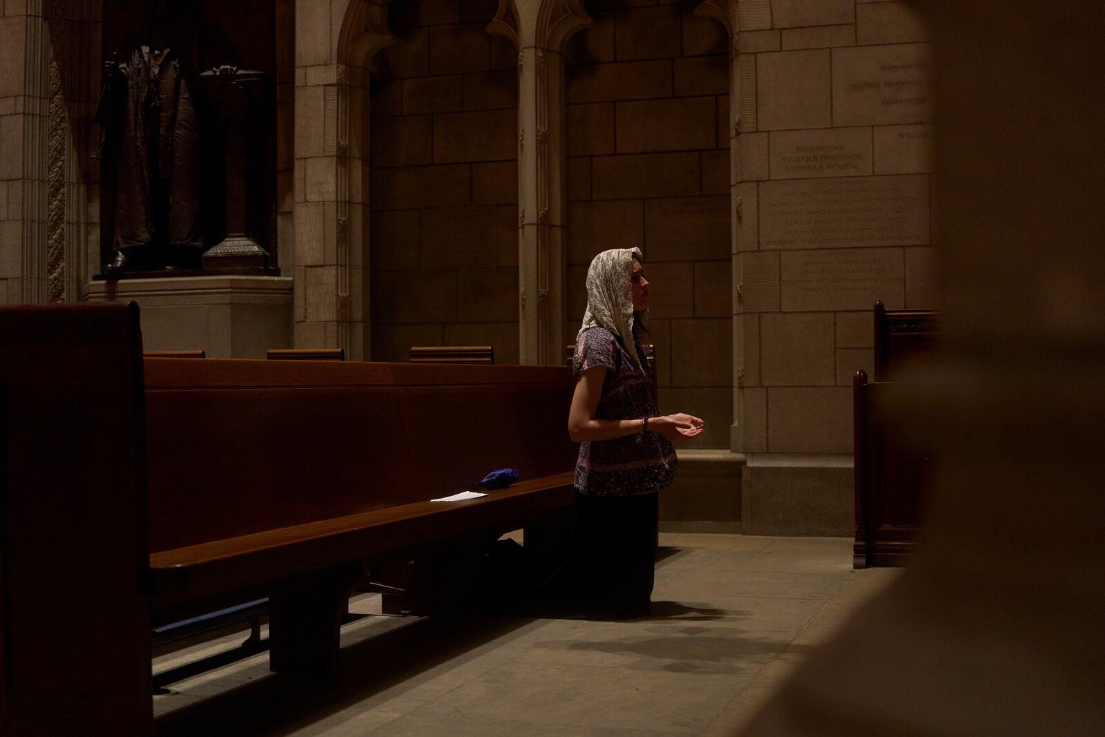 Savannah Nichols, visiting her boyfriend, altar server David Kim, from Ohio, prays after a service at the Princeton University chapel in Princeton, N.J., on Friday, May 16, 2025. (AP Photo/Luis Andres Henao)