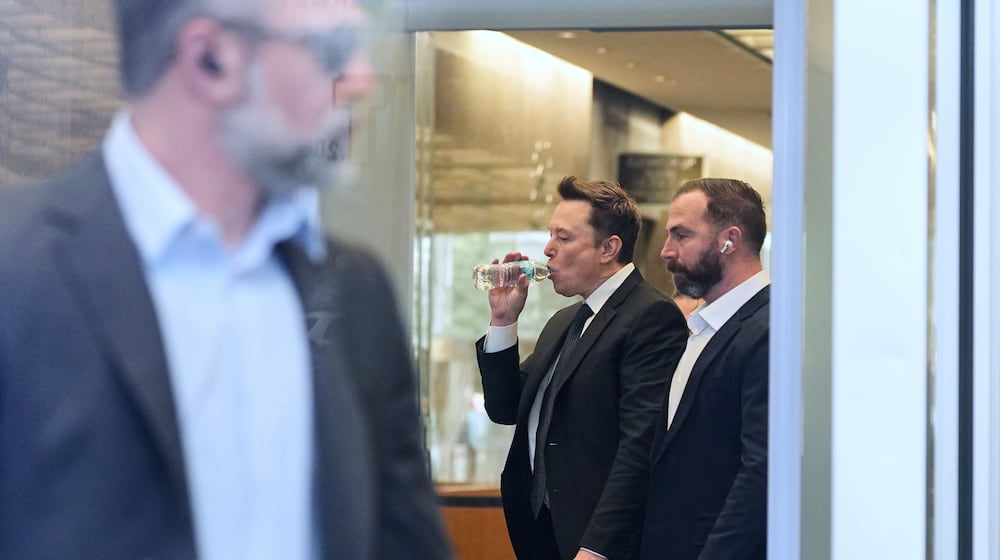 Elon Musk, center, arrives for a Twitter shareholder trial at the U.S. District Court for the Northern District of California, Wednesday, March 4, 2026, in San Francisco. (AP Photo/Godofredo A. Vásquez)