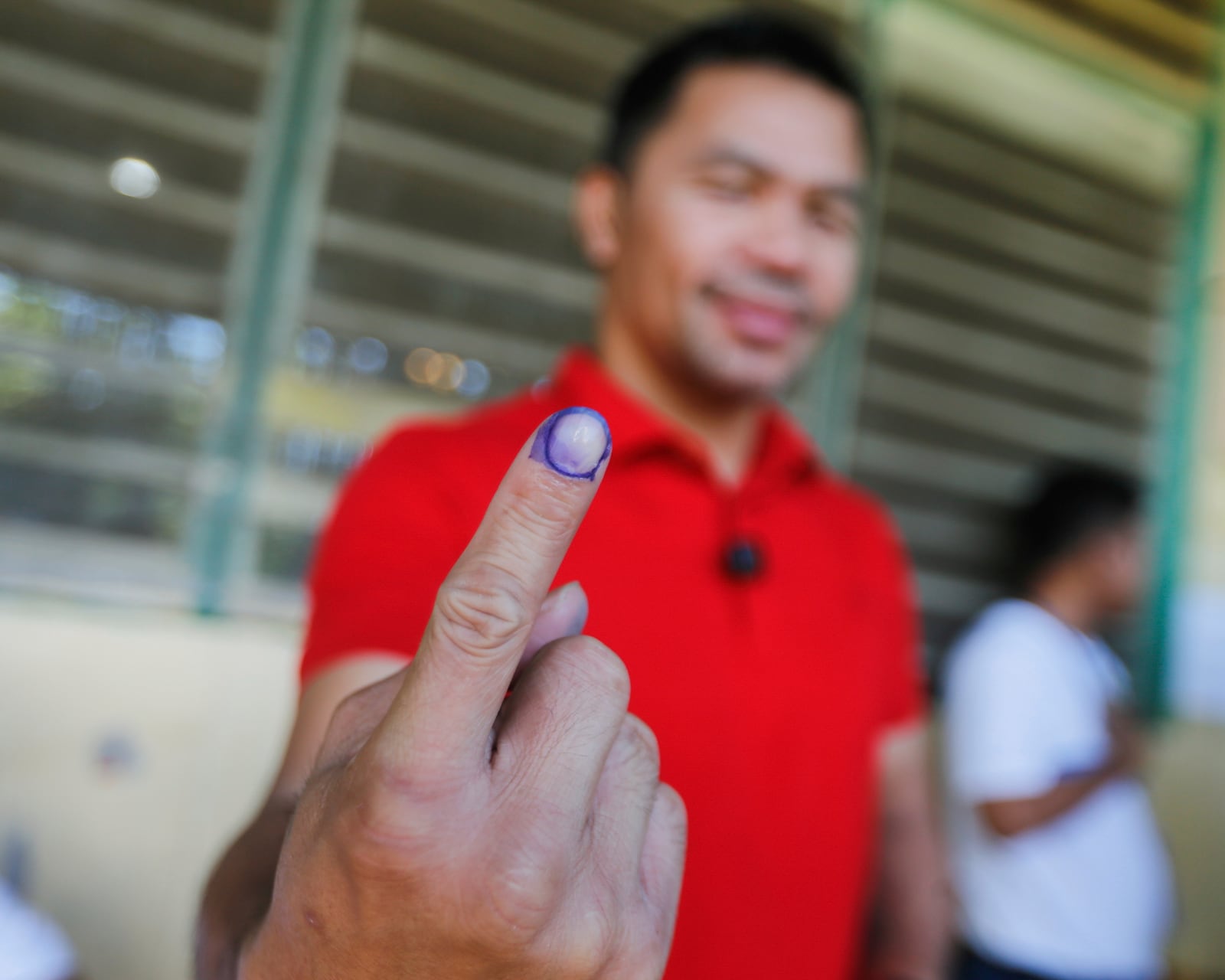 In this photo provided by Team Pacquiao, Filipino boxing hero and former senator Manny Pacquiao shows the indelible ink on his finger after casting his vote at Kiamba Central Elementary School in Kiamba, Sarangani province, southern Philippines, Monday, May 12, 2025. (Wendell Alinea/Team Pacquiao via AP)