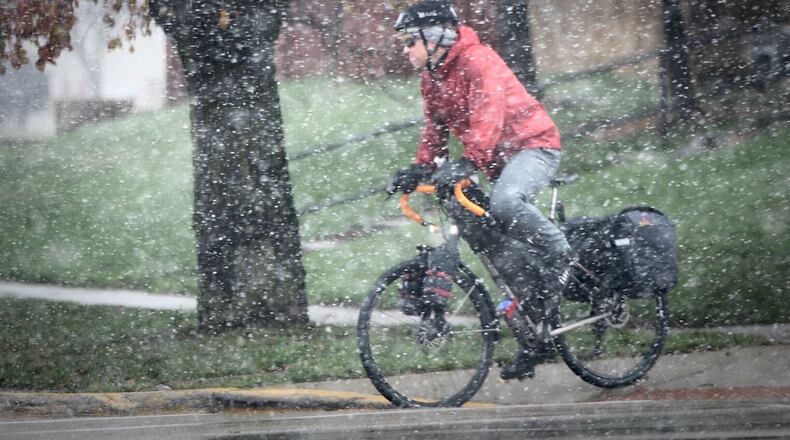 The snow didn't seem to slow down this bicyclist riding along Main Street in Xenia Monday, Nov. 30, 2020. MARSHALL GORBY\STAFF