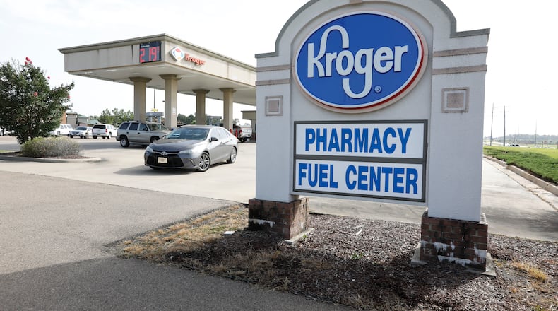 FILE - In this June 26, 2019, file photo a customer exits a Kroger fueling center in Flowood, Miss. Two of the nation’s largest grocers have agreed to merge in a deal that would help them better compete with Walmart, Amazon and other major companies that have stepped into the grocery business. Kroger on Friday, Oct. 14, 2022 bid $20 billion for Albertsons Companies Inc., or $34.10 per share. (AP Photo/Rogelio V. Solis, File)
