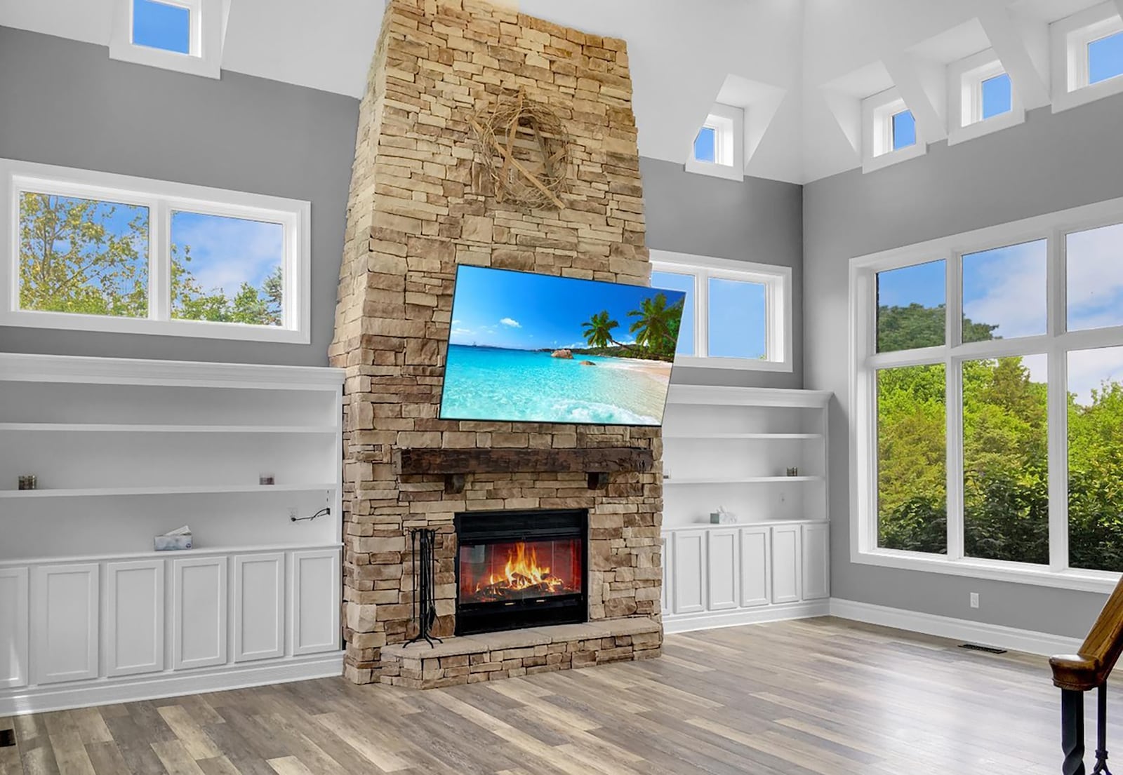 The living room features luxury vinyl tile flooring, a stacked stone floor to ceiling fireplace and cathedral ceilings. It also has built in bookcases and cabinets. CONTRIBUTED