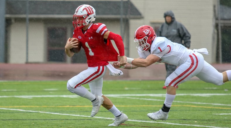 Denison University defensive back Dara Laja grabs the jersey of Wittenberg University wide receiver Sam Kayser as he runs towards the end zone during their game against Denison on Saturday at Edwards-Maurer Field in Springfield. Kayser scored a touchdown on the play. CONTRIBUTED PHOTO BY MICHAEL COOPER