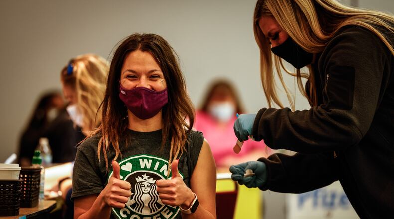 Lindsey Martin, 30, from Dayton, received her first COVID-19 vaccine at the Dayton Convention Center Wednesday Dec. 8, 2021. Martin said she was pushed to get the vaccine by her family requiring it to attend holiday gatherings. After missing Thanksgiving, Martin wants to see her family, particularly her grandmother on Christmas. “I’m thinking that I might not have this opportunity again with her declining health,” Martin said. “My dad has warned me that this might be the last round of holidays for them.” JIM NOELKER/STAFF