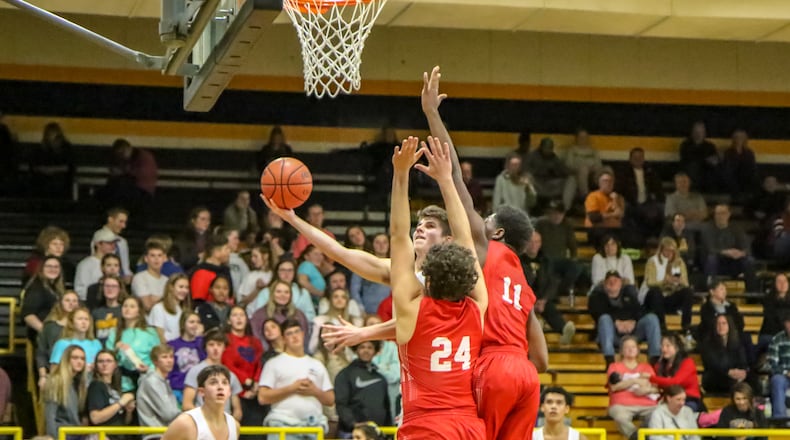Shawnee High School senior Isaac Siemon attempts a layup during their game against London on Friday night in Springfield. The Red Raiders won 54-36. CONTRIBUTED PHOTO BY MICHAEL COOPER