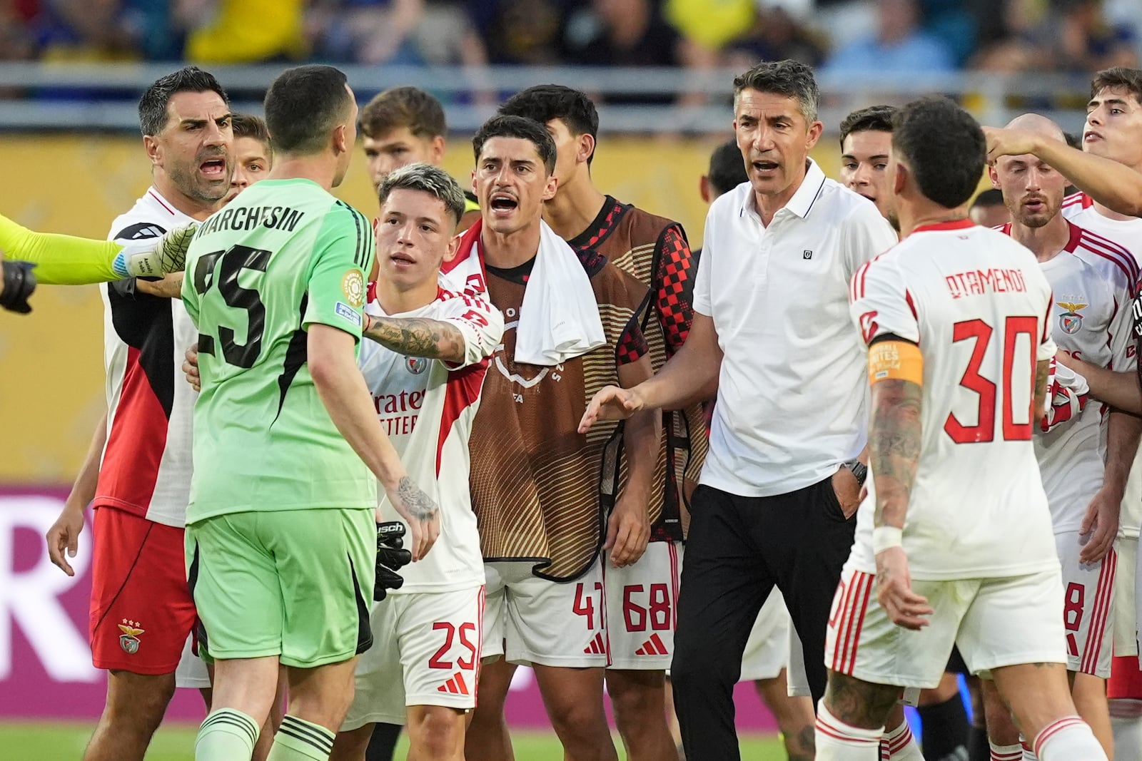 Boca Juniors' Agustin Marchesin (25) talks to Benfica manager Bruno Lage, center right, at the end of the Club World Cup group C soccer match between Boca Juniors and Benfica in Miami Gardens, Fla., Monday, June 16, 2025. (AP Photo/Rebecca Blackwell)
