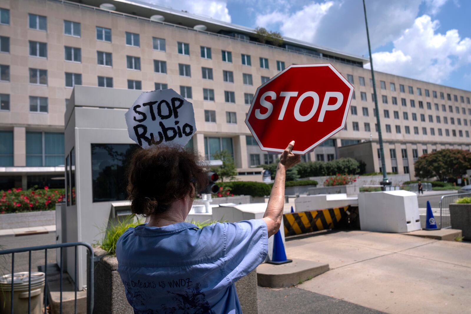 Former Foreign Service employee Anne Bodine of Arlington, Va., demonstrates against potential layoffs at the State Department, Friday, July 11, 2025, in Washington. (AP Photo/Mark Schiefelbein).