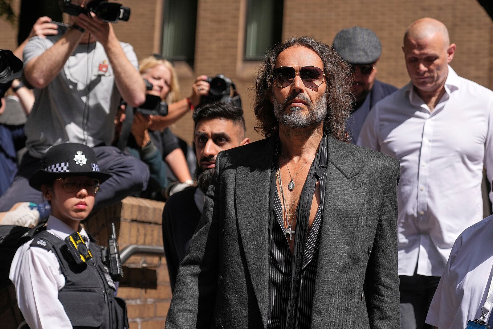English comedian and actor Russell Brand leaves Southwark Crown Court where he is charged with rape and sexual assault in London, Friday, May 30, 2025.(AP Photo/Alastair Grant)