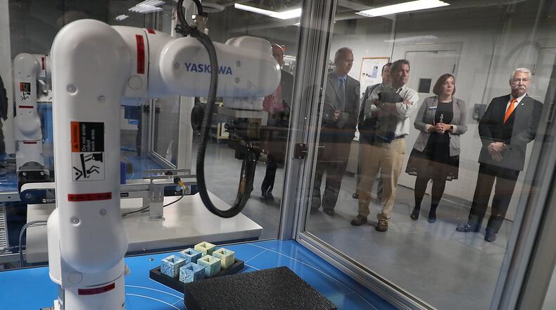 Visitors tour the new Sweet Manufacturing Center at Clark State Community College following its dedication Thursday, Dec. 6, 2018. BILL LACKEY/STAFF