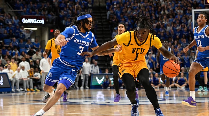 Saint Louis' Trey Green (3) defends against Virginia Commonwealth's Nyk Lewis (1) during the first half of an NCAA college basketball game, Friday, Feb. 20, 2026, in St. Louis. (AP Photo/Lexie Knight)