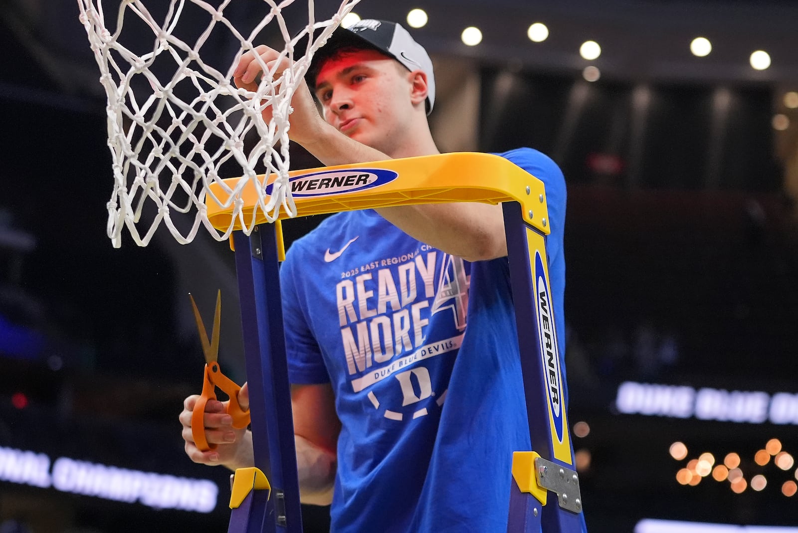 Duke forward Cooper Flagg (2) cuts a piece of the net after Duke defeated Alabama in an Elite Eight round NCAA college basketball tournament game, Saturday, March 29, 2025, in Newark, N.J. (AP Photo/Frank Franklin II)