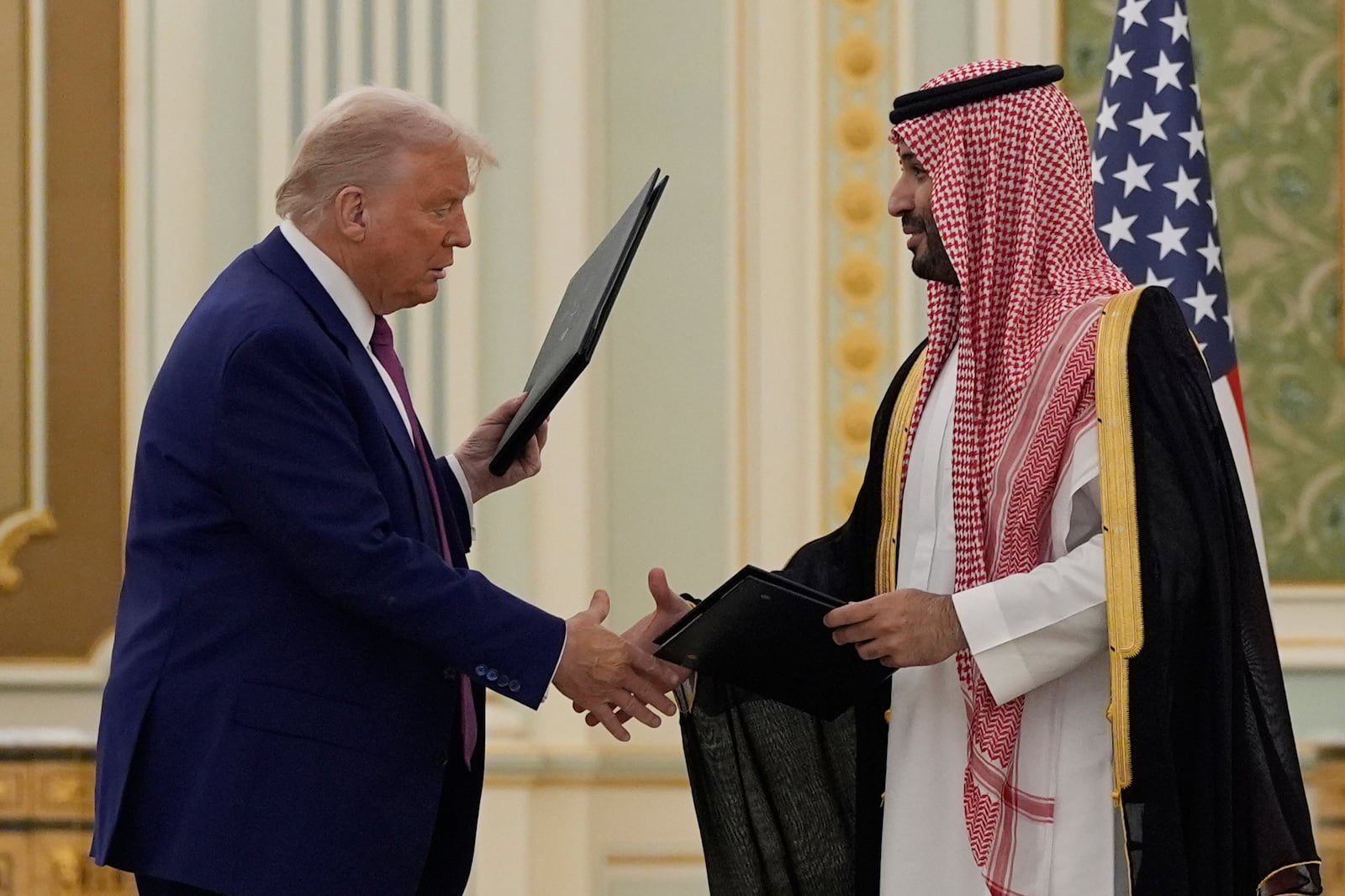 President Donald Trump and Saudi Crown Prince Mohammed bin Salman shake hands after exchanging documents during a signing ceremony at the Royal Palace in Riyadh, Saudi Arabia, Tuesday, May 13, 2025. (AP Photo/Alex Brandon)