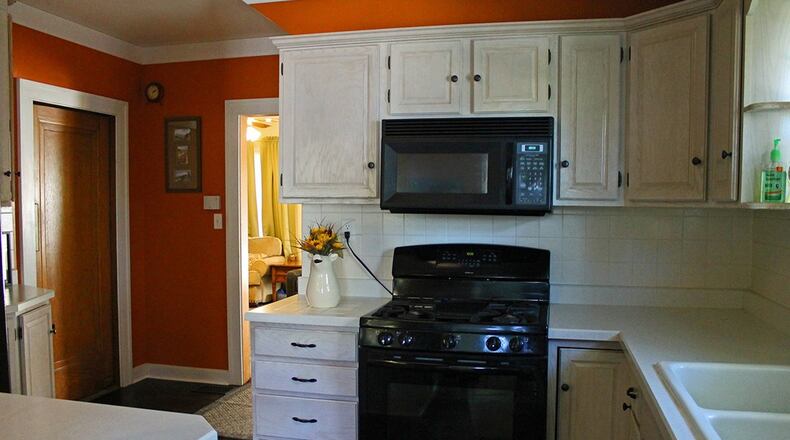 The updated kitchen boasts plenty of crisp, white cabinetry and ample counter space. There is also ceramic double sink.