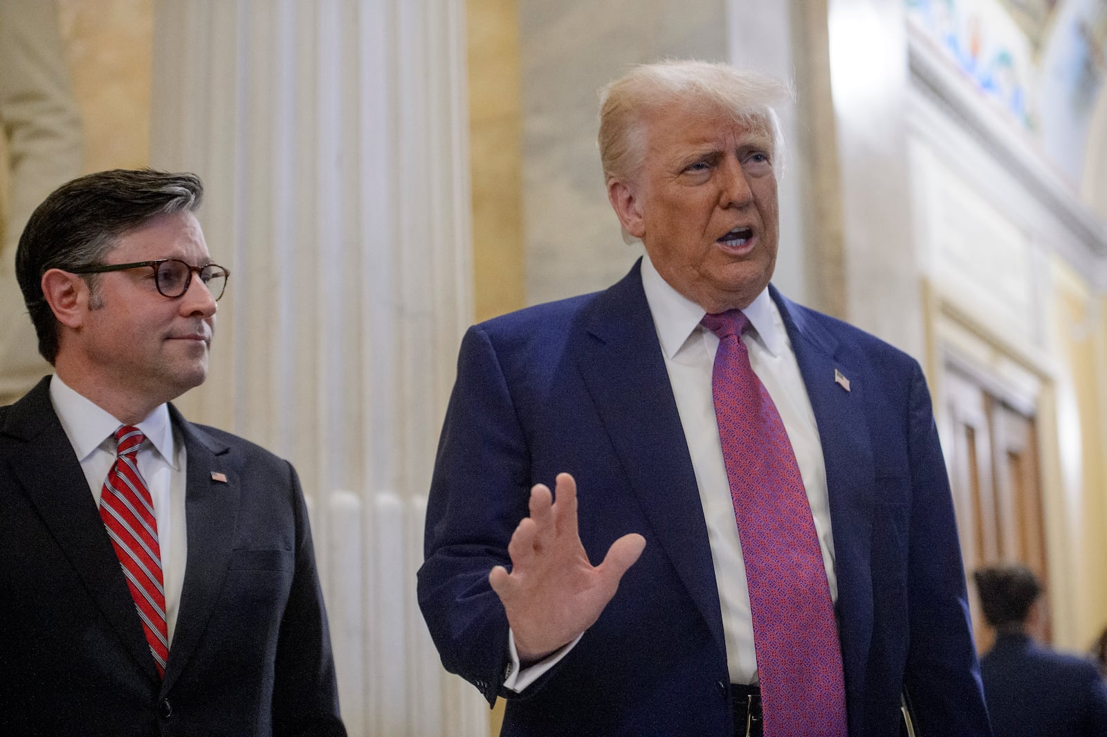 President Donald Trump, right, is joined by Speaker of the House Mike Johnson, R-La., as he arrives for a meeting with the House Republican Conference at the Capitol, Tuesday, May 20, 2025, in Washington. (AP Photo/Rod Lamkey, Jr.)