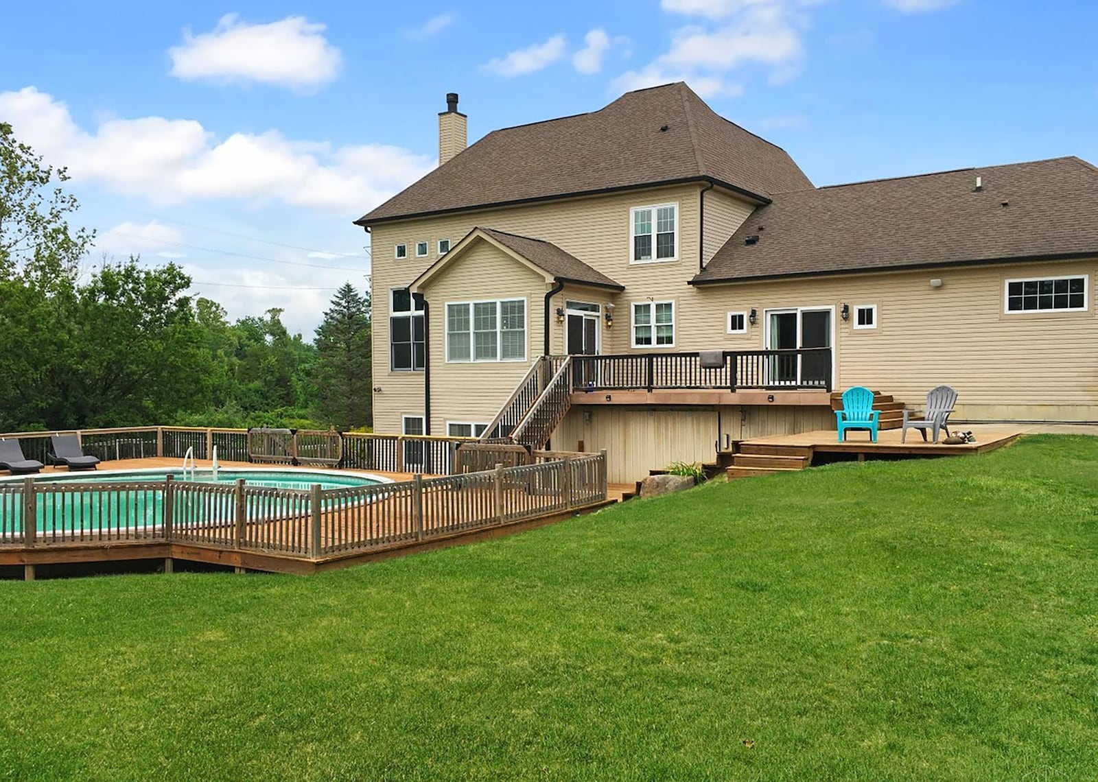 The back yard features an above ground pool surrounded by a wood deck and two levels of decks off the main level. CONTRIBUTED