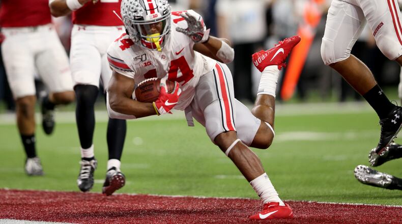 INDIANAPOLIS, INDIANA - DECEMBER 07: K.J. Hill #14 of the Ohio State Buckeyes runs the ball in for touchdown in the Big Ten Championship game against the Wisconsin Badgers during the third quarter at Lucas Oil Stadium on December 07, 2019 in Indianapolis, Indiana. (Photo by Justin Casterline/Getty Images)