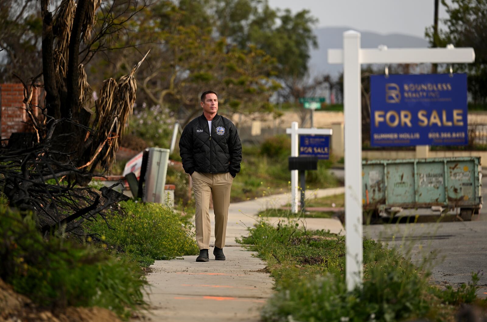 Supervisor Jeff Gorrell walks next to damage from the Mountain Fire along Old Coach Drive in Camarillo Wednesday, April 16, 2025, in Camarillo, Calif. (AP Photo/Wally Skalij)