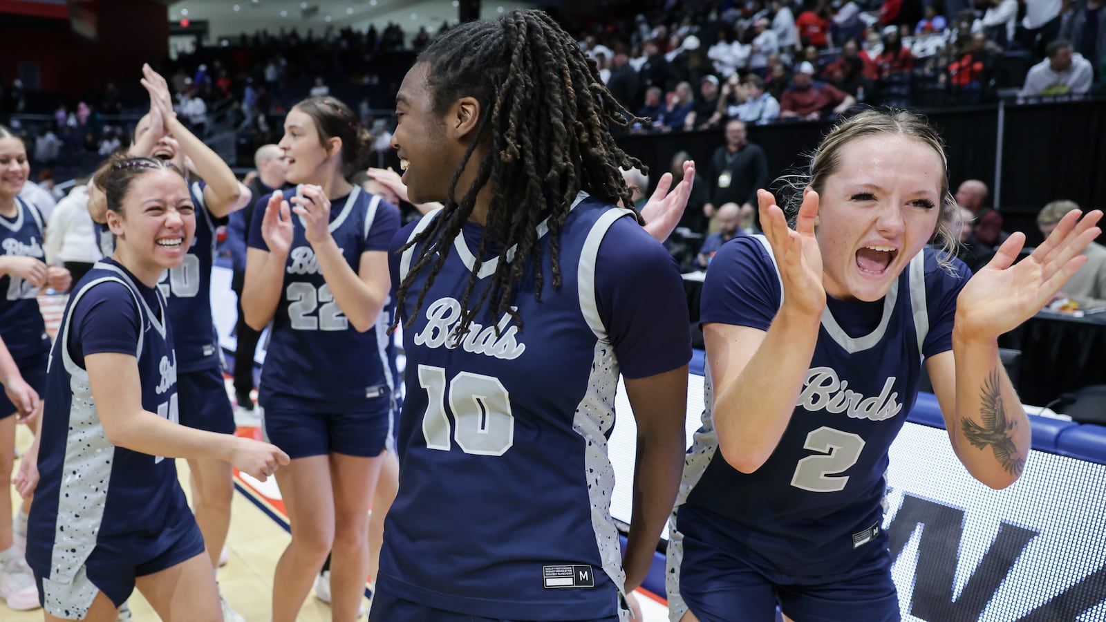 Fairmont senior guard Nico Cornett (right) celebrates with teammates following a 61-55 overtime win over Princeton in the Division I state final on Saturday, March 14 at University of Dayton Arena. The Firebirds trailed by seven points in the fourth quarter before storming back. BRYANT BILLING / STAFF