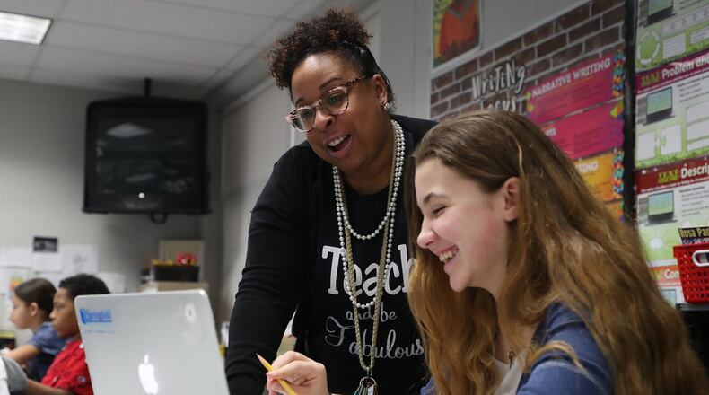 Taci Jones, English teacher at Kenwood Elementary School in the Springfield City School District, is one of four teachers chosen to receive the Excellence in Teaching Award at the Springfield Rotary Club meeting on March 16. BILL LACKEY/STAFF