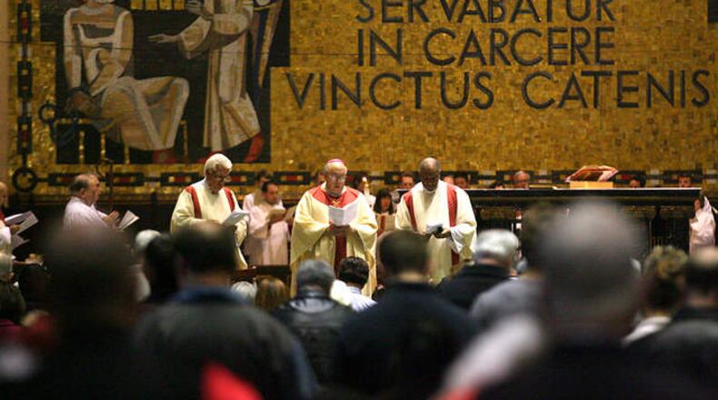 A Roman Catholic Mass is celebrated at St. Peter in Chains Cathedral in downtown Cincinnati to celebrate the election of Pope Francis in a 2013 file photo. Behind the altar, a mosaic in Latin says “Et Petrus quidem servabatur in carcere vinctus catenis,” which translates, “And Peter was kept in prison, bound in chains.” CONTRIBUTED