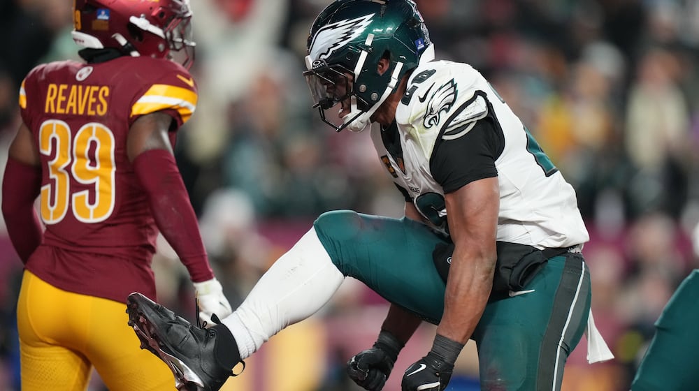Philadelphia Eagles running back Saquon Barkley, right, celebrates after a touchdown against the Washington Commanders during the second half of an NFL football game, Saturday, Dec. 20, 2025, in Landover, Md. (AP Photo/Stephanie Scarbrough)