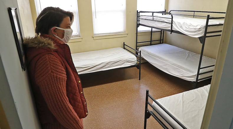 Elaina Bradley, executive director of Interfaith Hospitality Network, looks around one of the empty family rooms at Interfaith in this file photo from November 2021. The homeless shelter had been closed due to COVID-19 and had been placing homeless people in area hotels, but the program is ending and people are returning to the shelter. BILL LACKEY/STAFF